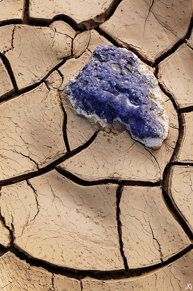 Dry mud holds onto this blue rock and provides some interesting patterns in Death Valley National Park.