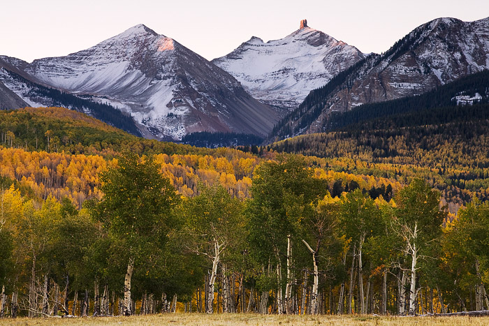 An autumn morning begins as the first light of the day hits Lizard Head Peak near the town of Telluride, Colorado.