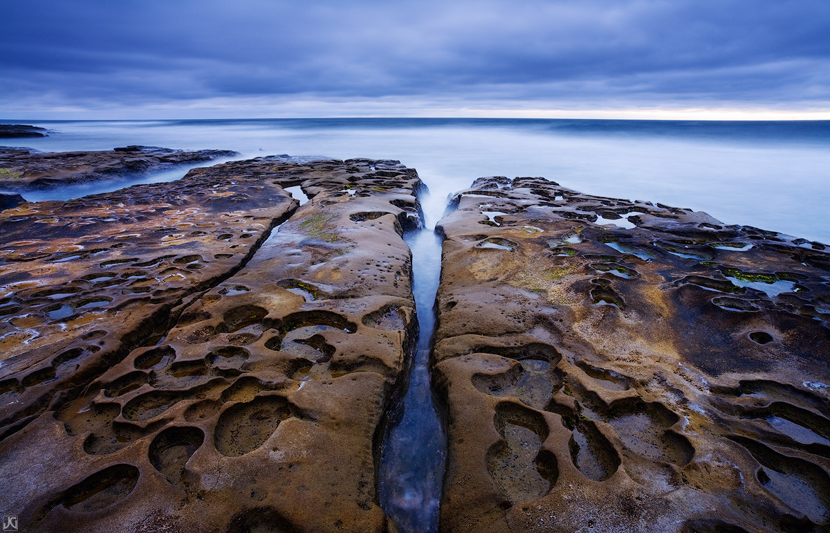 Unique formations along this section of coast near San Diego create an interesting foreground for the blue hues of &nbsp;cloudy...