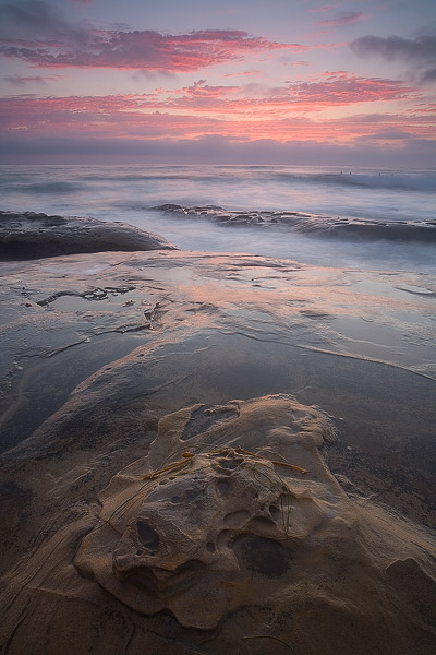Interesting rock formations point to another colorful sunset in La Jolla, California.