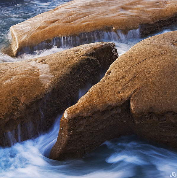 Square crop accentuates the water movements around the rocks.