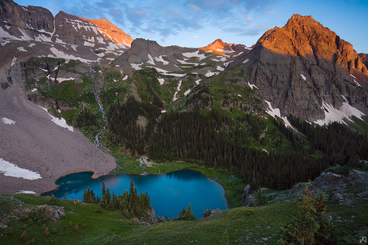 First light hits Dallas Peak above Lower Blue Lake during a summer backpacking trip.&nbsp;