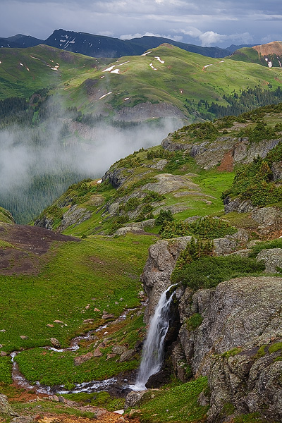 A waterfall flows from Porphyry Basin down into a gulch after a summer thunderstorm