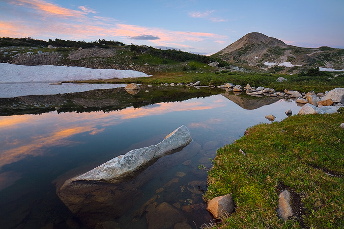 Sugarloaf Peak reflects in a small tarn in the Snowy Range of Wyoming.