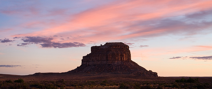 Fajada Butte glows, as the last light of the day brings color to the clouds above. Fajada Butte is a prominent landmark of Chaco...