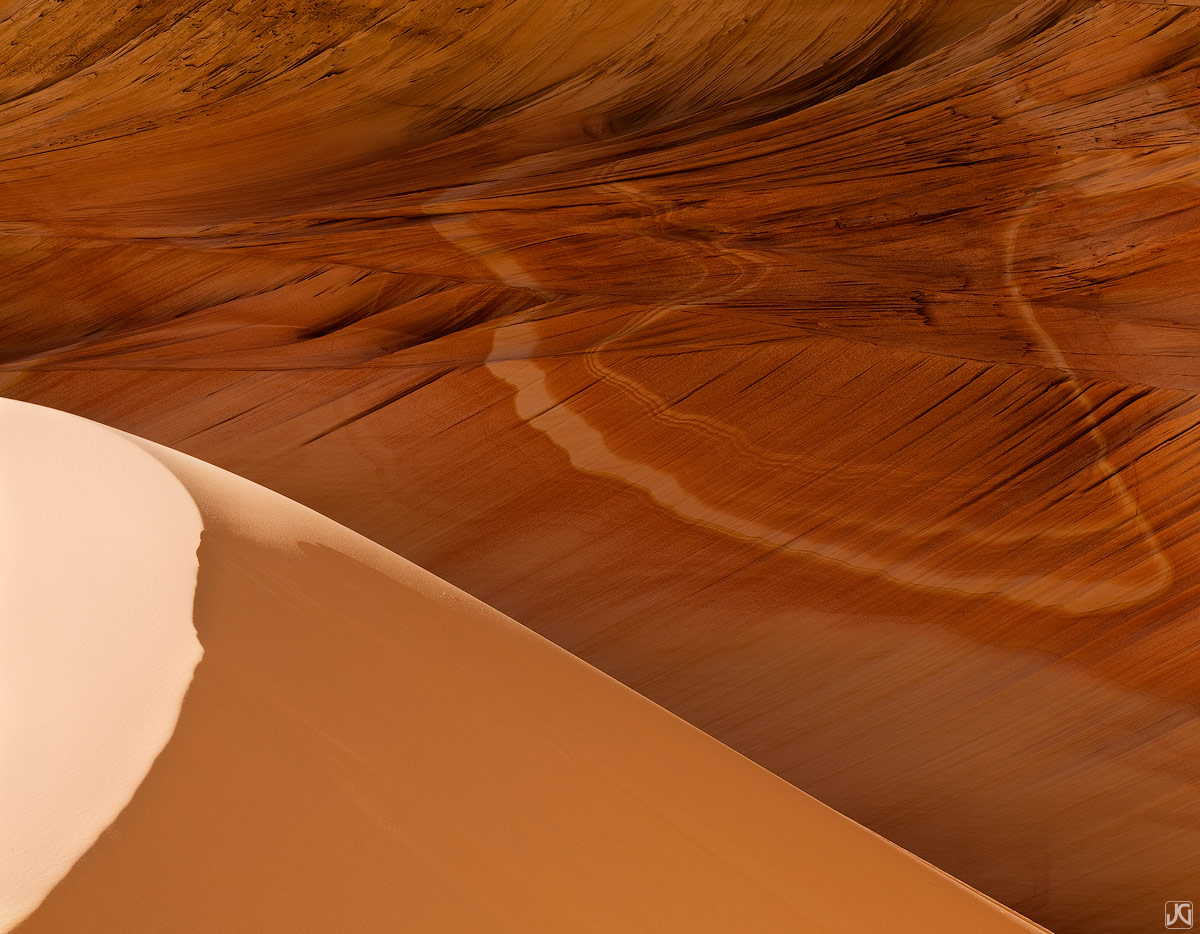 A small sand dune and streaks across the sandstone walls make this alcove above the Wave unique.