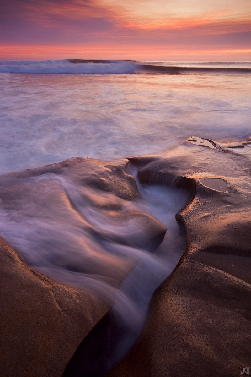 Soft sunset light and the incoming tide wash over this stretch of the beach in San Diego.&nbsp;