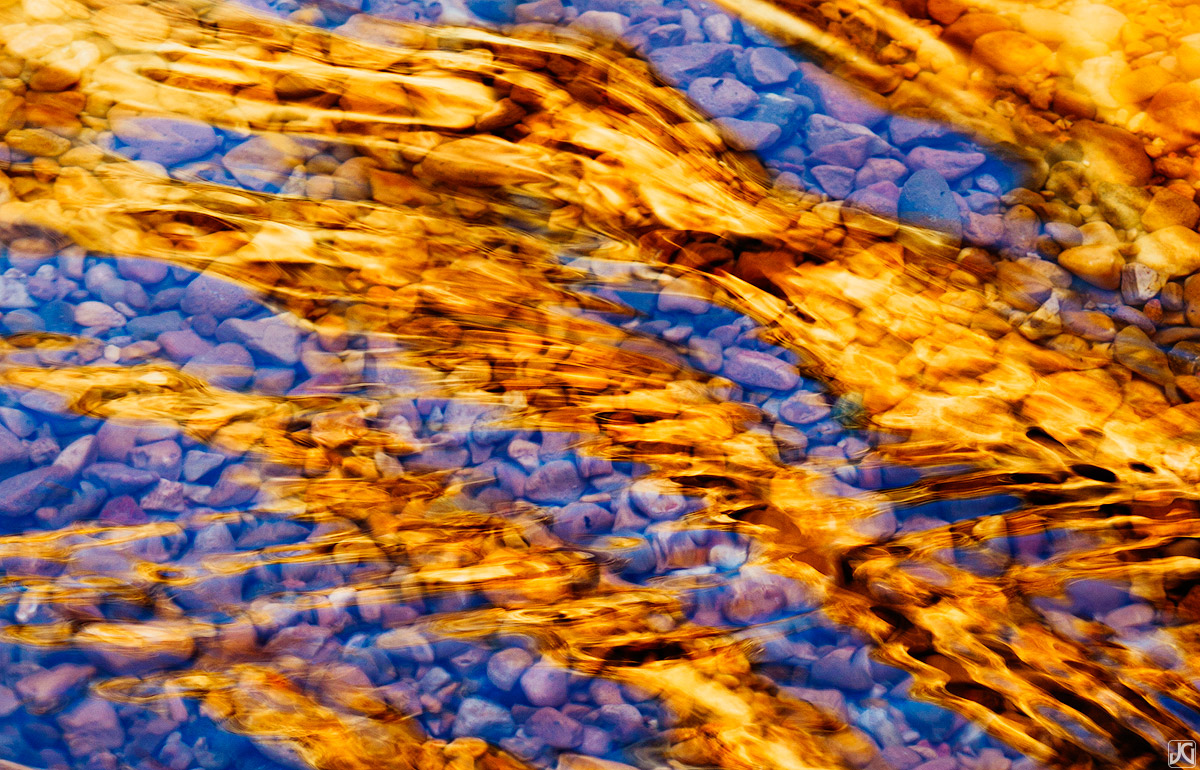 The canyon walls of Willis Creek reflect on the ripples in the water below, creating a golden abstract.