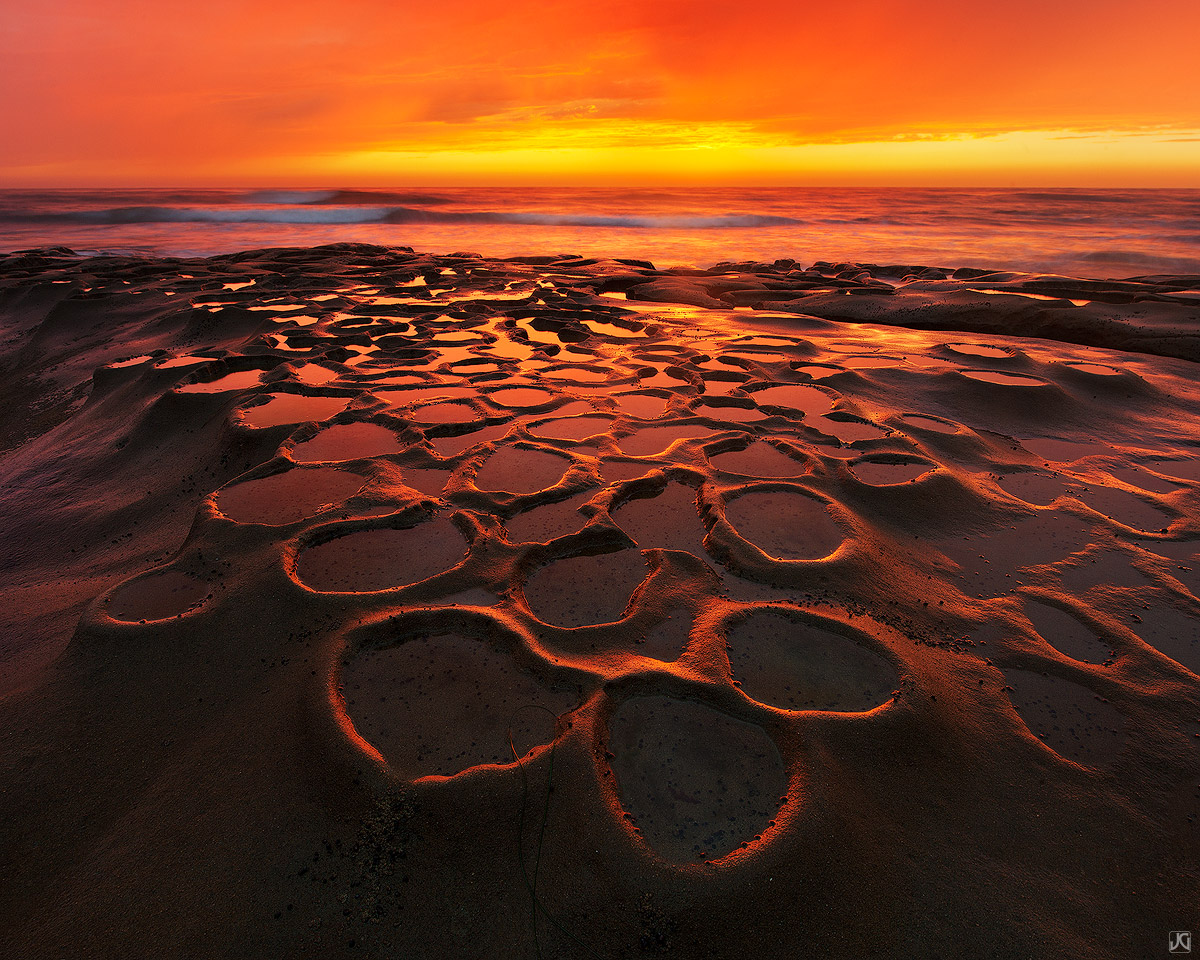 A gorgeous orange sunset signals the end of the day near San Diego. The "potholes" as I call them, are one of the most interesting...