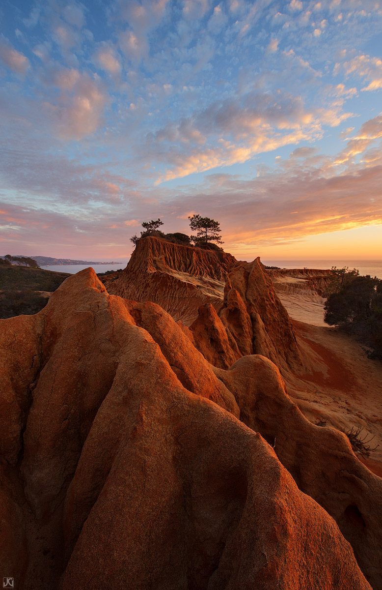 At the end of a trail at Torrey Pines State Reserve, sunset light creates a nice glow to the Broken Hill formation.