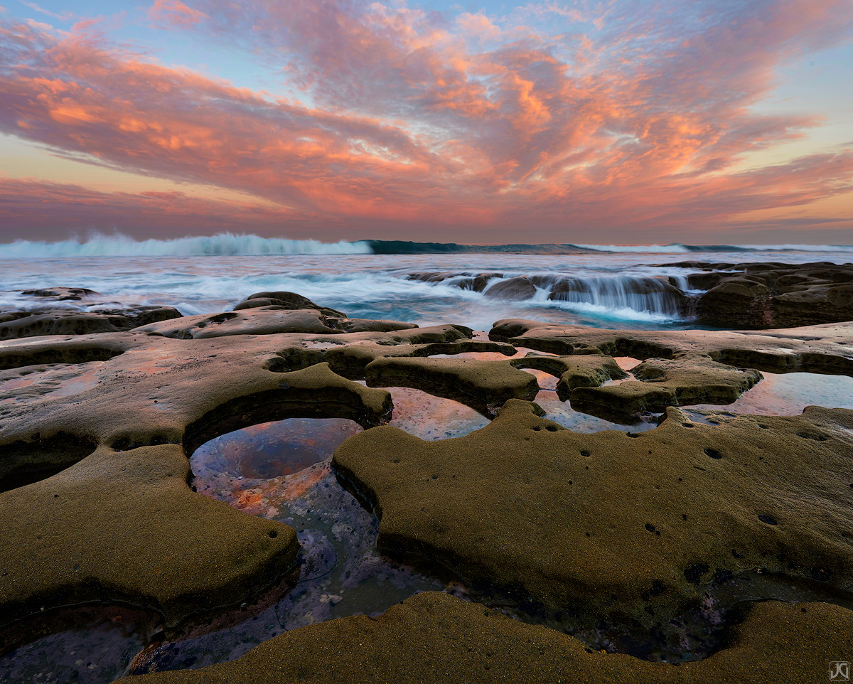 Early morning light catches these high clouds above the coast near San Diego, while some fun waves crash on the shore. It is...