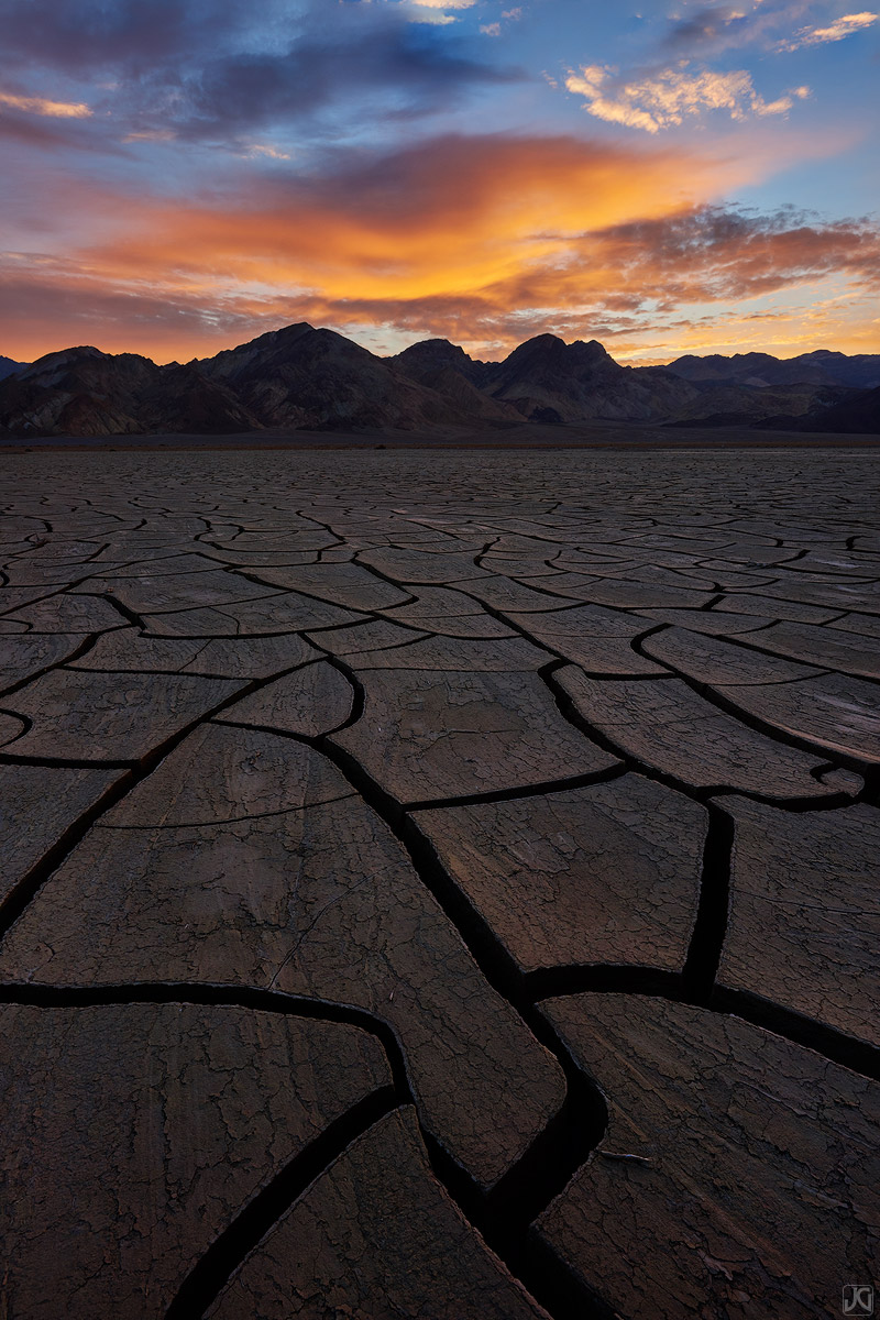 Sunrise lights up the clouds, the mud cracks and tiles glow, and the desert comes to life.