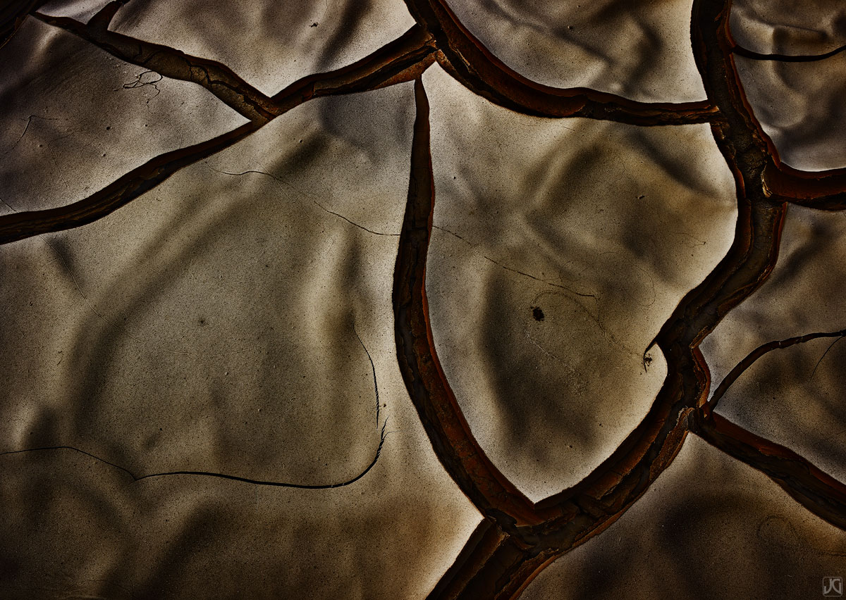 Mud cracks and patterns form wrinkles on the surface of a desert playa.