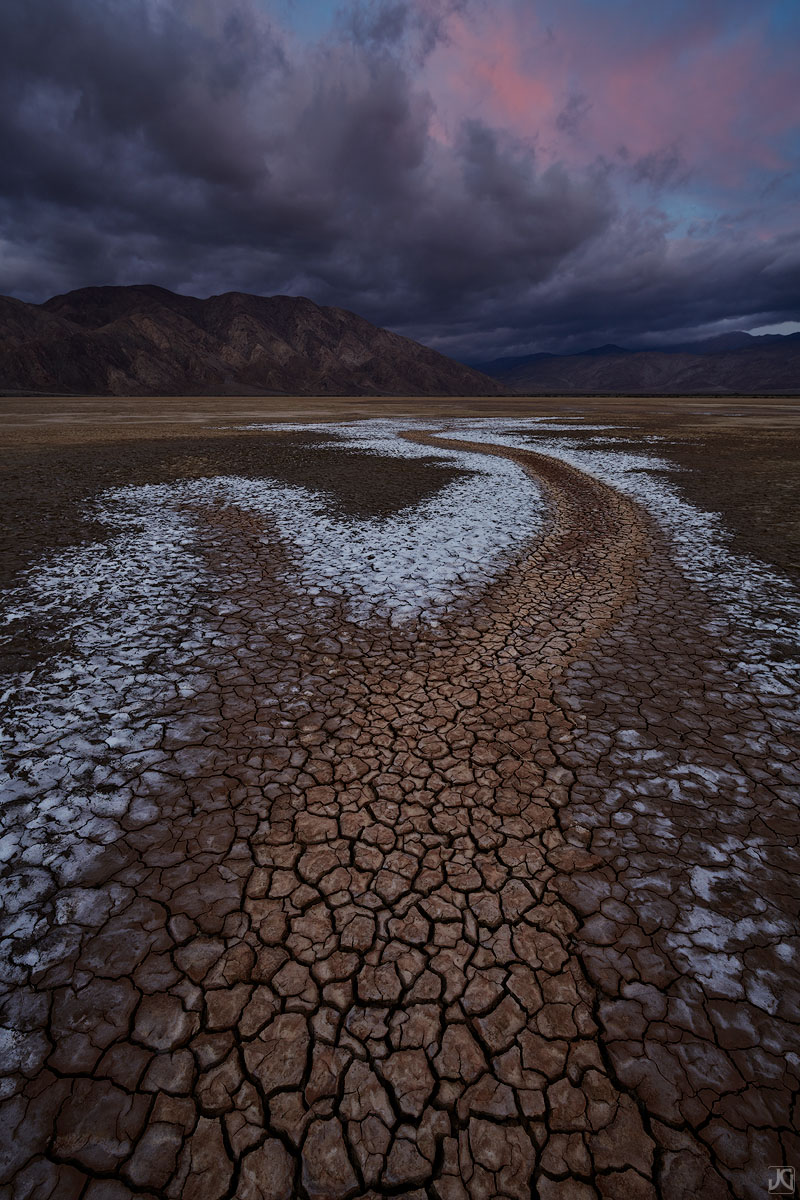 Seasonal streams empty into a large, desert playa where now only mud cracks remain.