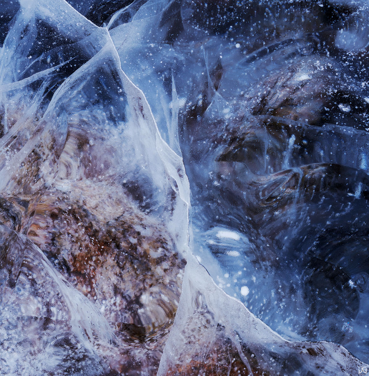 Peering down through the layers of ice, one can see shapes and patterns similar to looking through a telescope pointed at the...